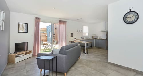 Modern Paris apartment at Résidence des Sables with living room, kitchen, terrace access, and inner courtyard view in Mably,
