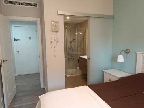 Master bedroom with en-suite bathroom featuring glass shower enclosure at Mediterranea Sunny Keys, Benicàssim