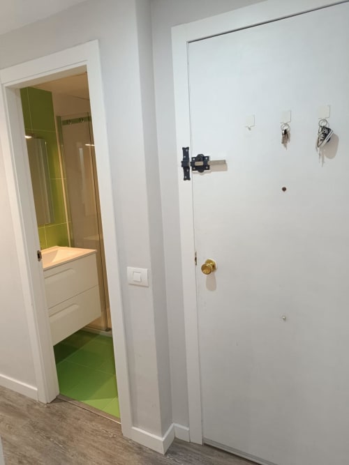 Hallway with white doors leading to bathroom and apartment entrance at Mediterranea Sunny Keys, Benicàssim