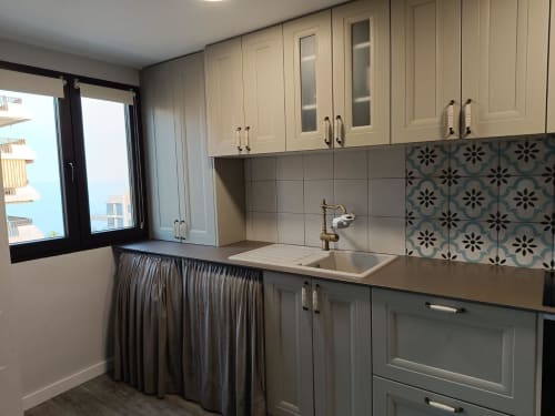 Modern kitchen in Riviera Sunny Flat, Benicàssim with cream cabinets, patterned backsplash, and sea view window