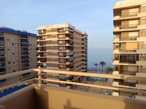 Benicàssim apartment building with sea view, Mediterranean coastal architecture overlooking beach and palm trees