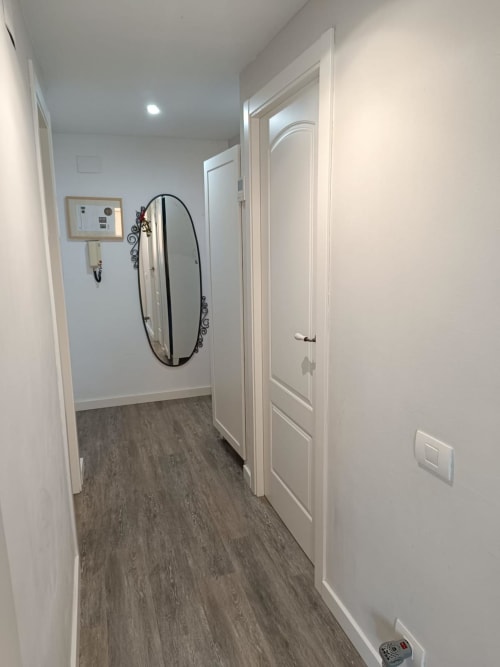 Modern hallway in Riviera Sunny Flat apartment at Mediterranea Sunny Keys, Benicàssim with white doors and wood flooring