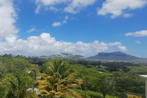 Panoramic mountain view from Joubarbe Résidence in Moka, Mauritius, with lush green valleys and coastal landscape