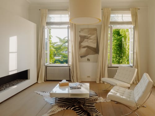 Bernard Suite at Castanea Business & Suites with fireplace, modern chairs, and garden views in Merelbeke-Melle