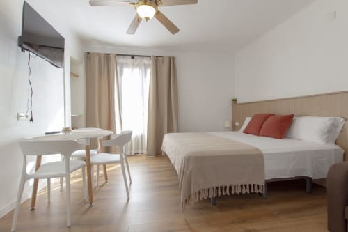 Dormitorio loft moderno en El Sol II, Tossa de Mar con cama de matrimonio, escritorio y acceso a balcón