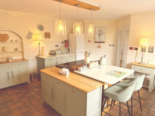 Luxury self-catering kitchen at The Usk Guest house, Brecon, with cream cabinets, wooden countertops, pendant lighting, and