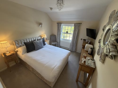 Luxury bedroom at The Usk Guest House in Brecon with queen bed, mountain views, and contemporary décor