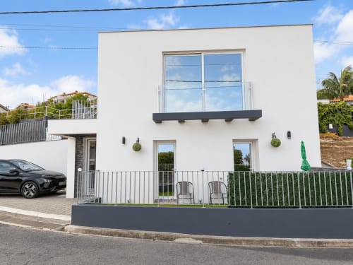 Modern white villa with large windows and dark trim, Sunshine House 85 at Check Madeira in Ribeira Brava, Portugal