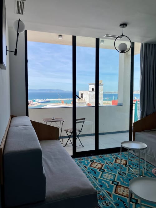 Chambre d'hôtel moderne chez SAMYAflat Tanger avec vue panoramique sur la mer, mobilier contemporain et paysage côtier