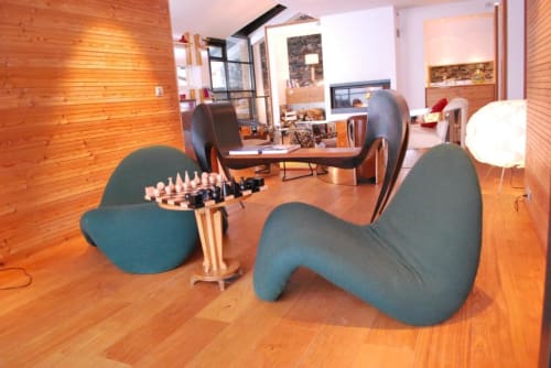 Espace de vie moderne au Chalet Violettes avec sièges design, table de jeu d'échecs et intérieurs en bois à Villaroger