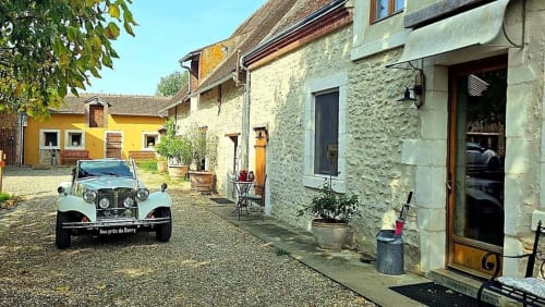Aux Prés Du Berry, a charming French countryside B&B in Chavin, features stone buildings and a vintage car