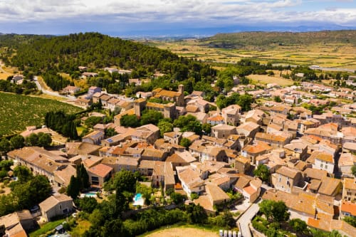 Aerial view of Fontcouverte village with terracotta roofs, nestled in verdant Provence countryside near Domaine Le Piboul