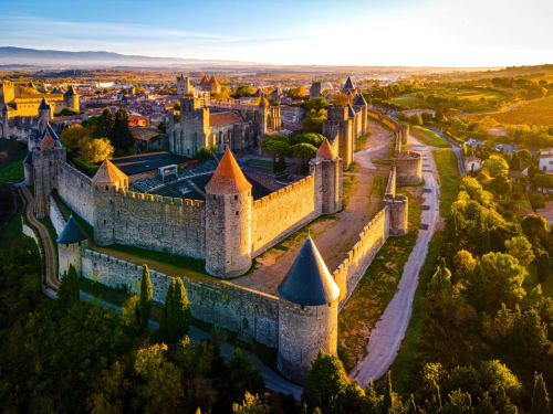 Aerial view of medieval Carcassonne fortress with stone walls and towers overlooking Fontcouverte, France