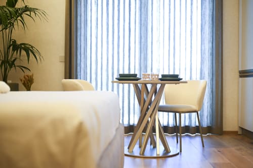 Modern dining area in Conchiglia apartment at Vimini Apulian Experience, Bari, with striped sea-view curtains