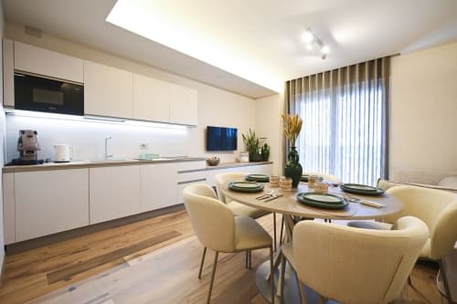 Modern kitchen and dining area at Vimini Apulian Experience, Levante apartment in Bari with cream furnishings and sea view