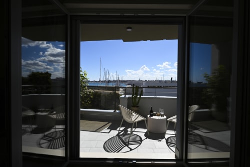 Levante apartment balcony at Vimini Apulian Experience with sea view over Bari marina and sailboats
