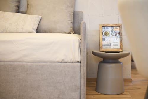 Ginestra apartment bedroom with gray bed, modern pedestal table, and WiFi information frame at Vimini Apulian Experience,