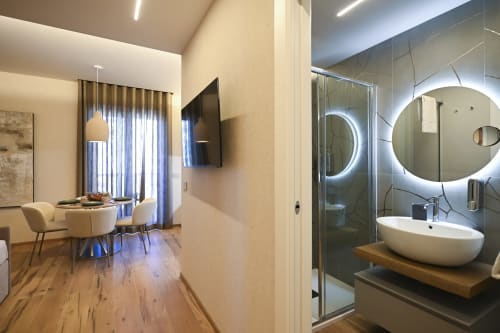Ginestra apartment at Vimini Apulian Experience in Bari features modern bathroom with round mirror and dining area with