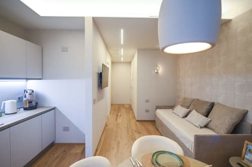Ginestra apartment at Vimini Apulian Experience in Bari features modern kitchen, living area with sofa, and wooden floors