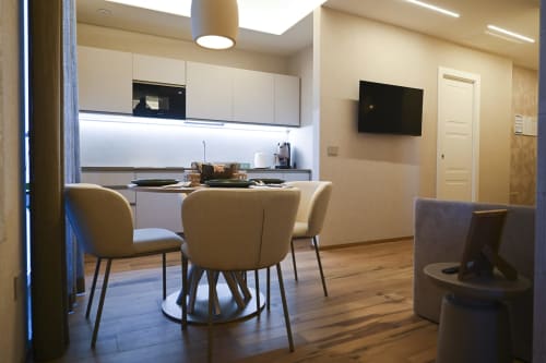 Modern Ginestra apartment at Vimini Apulian Experience in Bari with kitchen, dining area, and beige seating