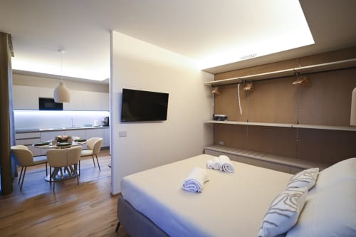 Ginestra apartment bedroom at Vimini Apulian Experience hotel in Bari, with modern furnishings, kitchenette, and garden view