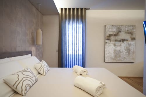 Ginestra bedroom at Vimini Apulian Experience, Bari - modern apartment with white bedding, patterned pillows, rolled towels,