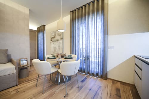 Ginestra apartment at Vimini Apulian Experience in Bari featuring dining area with round table, modern white chairs, and blue