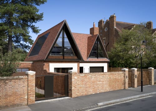 Modern brick villa with distinctive A-frame windows at The Coach House, 100 Banbury Road, featuring secure brick entrance.