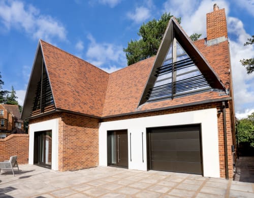 The Coach House villa at 100 Banbury Road features modern brick architecture with angular rooflines and large windows