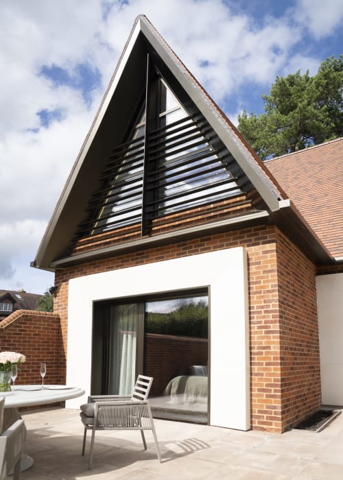 Modern triangular gable extension with black louvered windows at The Coach House, Banbury Road boutique hotel