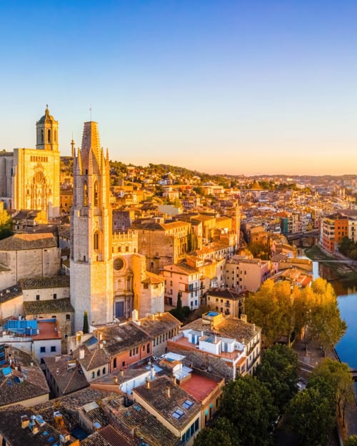 Golden sunset view of Girona cathedral and medieval old town with river, Alemanys 5 boutique hotel