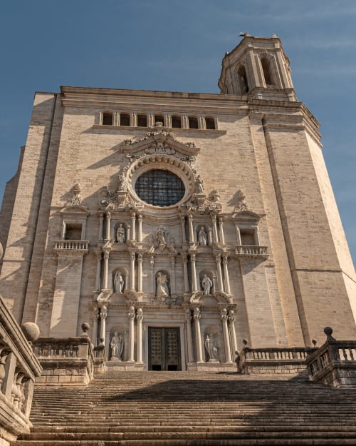 Historic stone cathedral facade with ornate bell tower in Girona, Spain near Alemanys 5 hotel