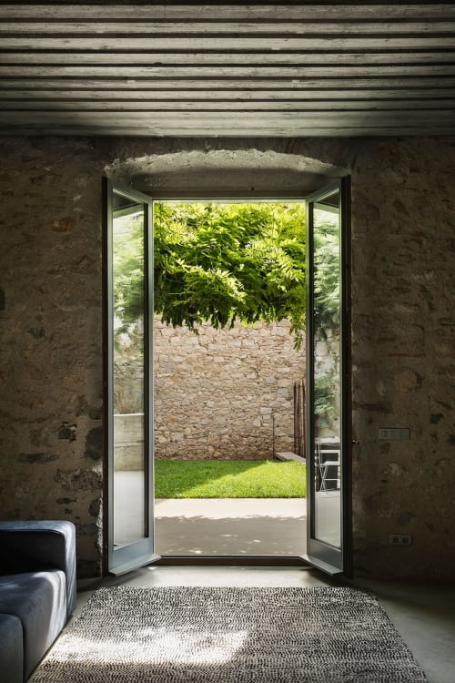 Modern double doors opening to courtyard garden at Alemanys 5 boutique hotel in Spain