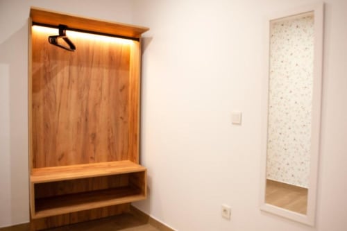Armario de madera con banco integrado y espejo en Habitación Doble del Hostal Restaurante Angel, Huelma