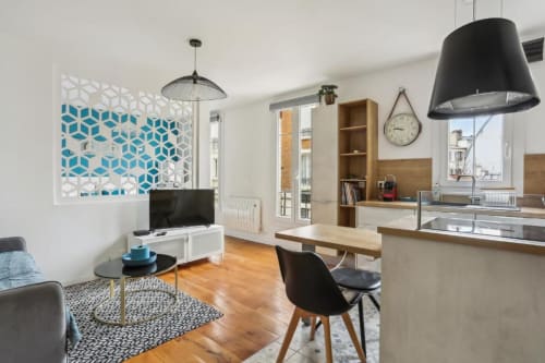 Modern Deluxe apartment at Résidence Aurmat Paris with open kitchen, dining area, living space, and geometric wall art