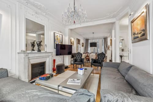 Elegant Trocadéro Apartment living room at Résidence Aurmat Paris with fireplace, chandelier, and modern furnishings