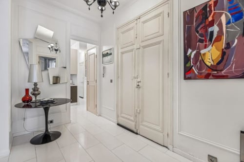 Modern hallway in Trocadéro Apartment at Résidence Aurmat Paris with white doors, contemporary art, and elegant furnishings