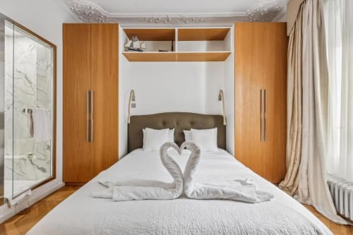 Trocadéro Apartment bedroom at Résidence Aurmat with wooden wardrobes, white bedding, and marble bathroom in Paris