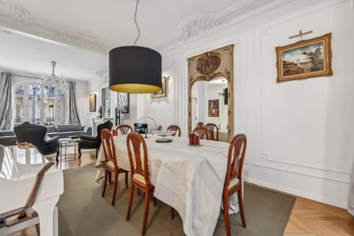 Elegant Trocadéro Apartment dining room at Résidence Aurmat Paris with wooden chairs, white tablecloth, and classic décor