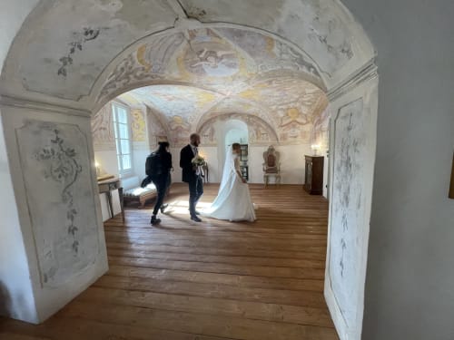 Bride in white dress at Roseto del Drago historic chapel with frescoed ceilings in Ponte In Valtellina