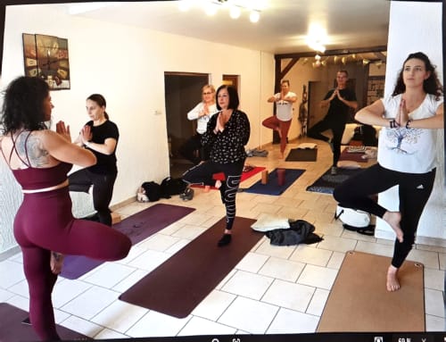 Yoga class in progress at Chez Mariebel' cottage in Ottonville, France with participants exercising on mats indoors.