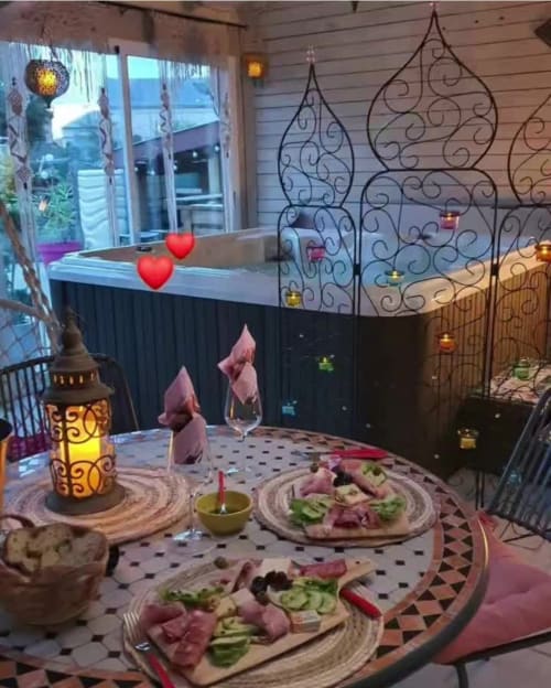 Romantic dinner setup at Chez Mariebel' cottage in Ottonville with plated cuisine, candlelit ambiance, and decorative