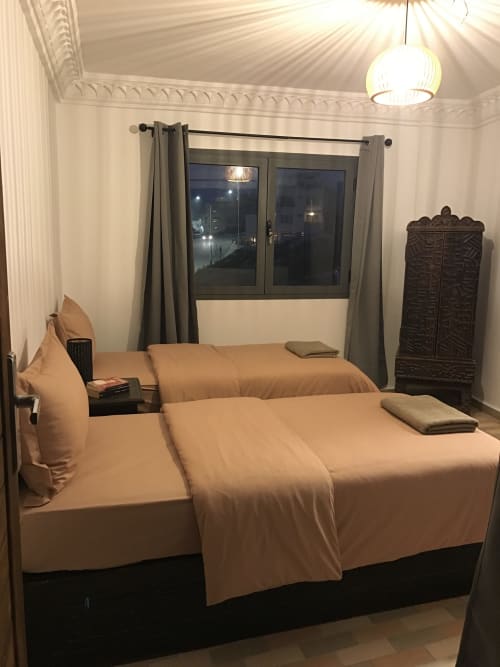 Tagante apartment bedroom with sea view at Imsouane Surf Paradise, featuring twin beds and balcony overlooking the ocean