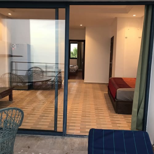 TILILT apartment at Imsouane Surf Paradise showing open-plan living area with dining table, seating, and kitchen access