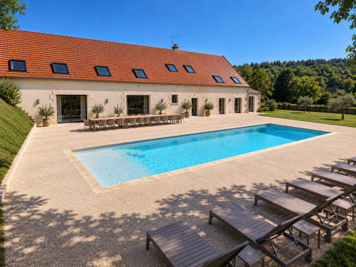 Vindihouses luxury villa in Epinac with rectangular pool, terrace seating, and red-roofed contemporary home