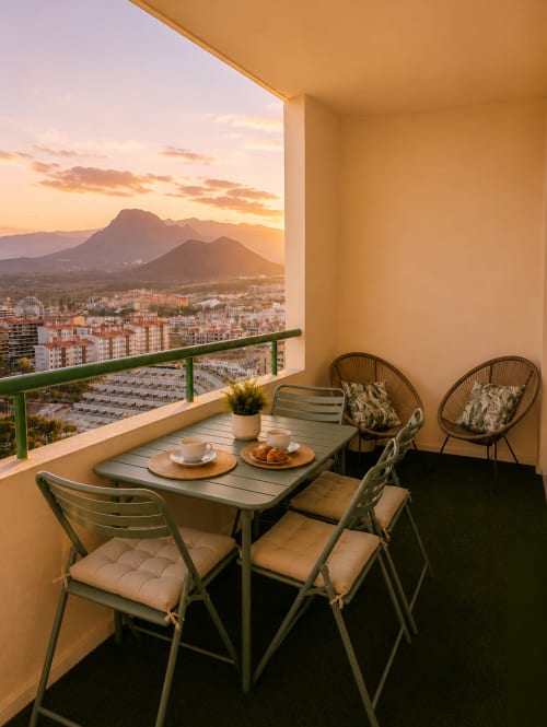 Sunset balcony with dining table at Manage Home Tenerife apartment, Los Cristianos, mountain views