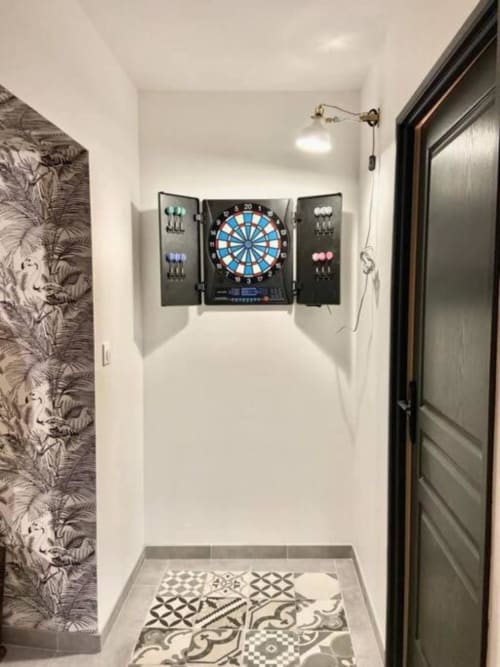 Narrow hallway with electronic dartboard and storage in Vindihouses boutique B&B, Epinac France