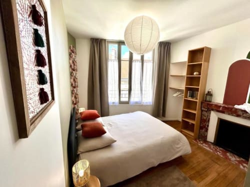 Helles Schlafzimmer im Vindihouses B&B in Epinac mit Queensize-Bett, Holzregalen, Pendelleuchte und Balkonblick