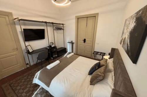 Modern bedroom at Moon Rooms By Celeste in Catania with canopy bed, desk, and contemporary furnishings