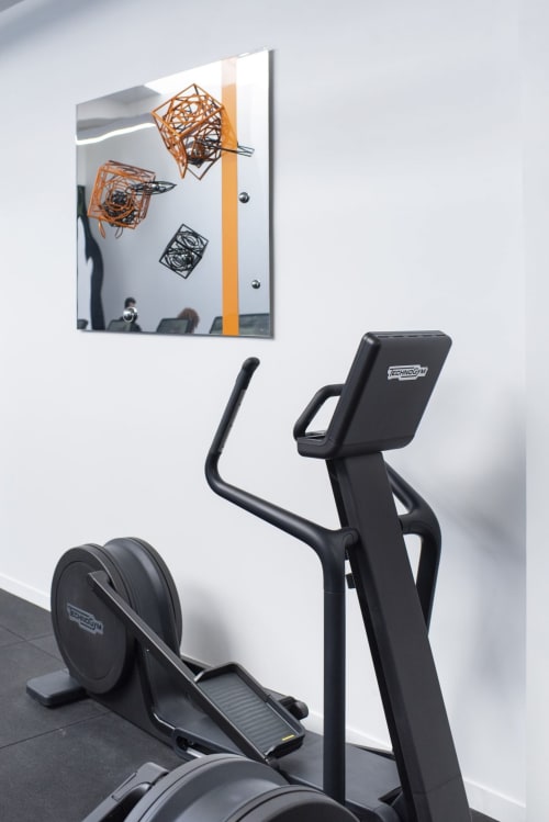 Modern gym at Résidence Aurmat boutique hotel with elliptical machine and abstract wall art in Paris Boulogne